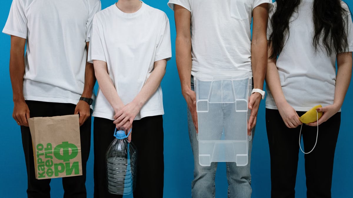 Four adults wearing makeshift protective gear against a blue backdrop.